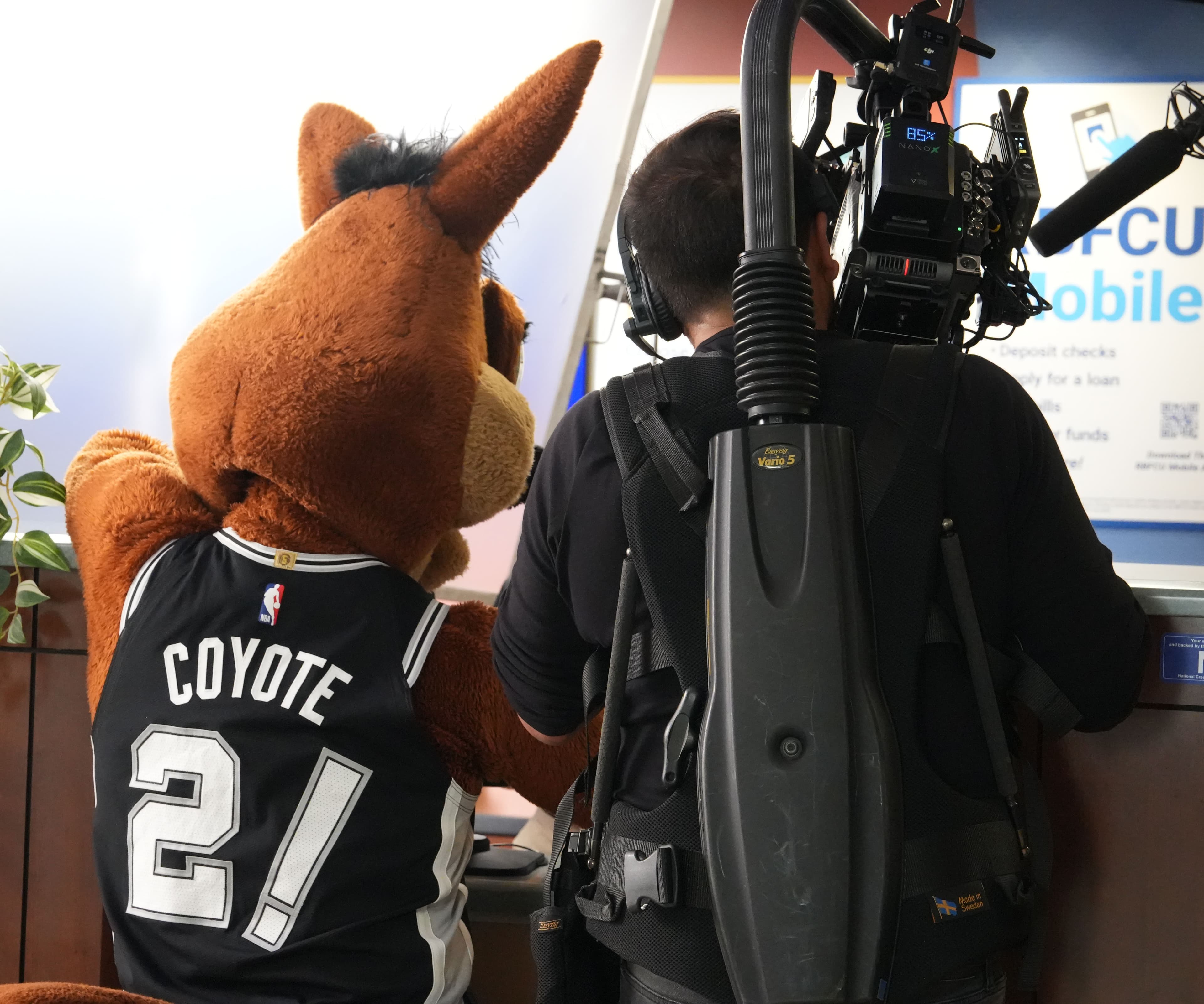 Media Bar Productions camera operator filming with the San Antonio Spurs Coyote