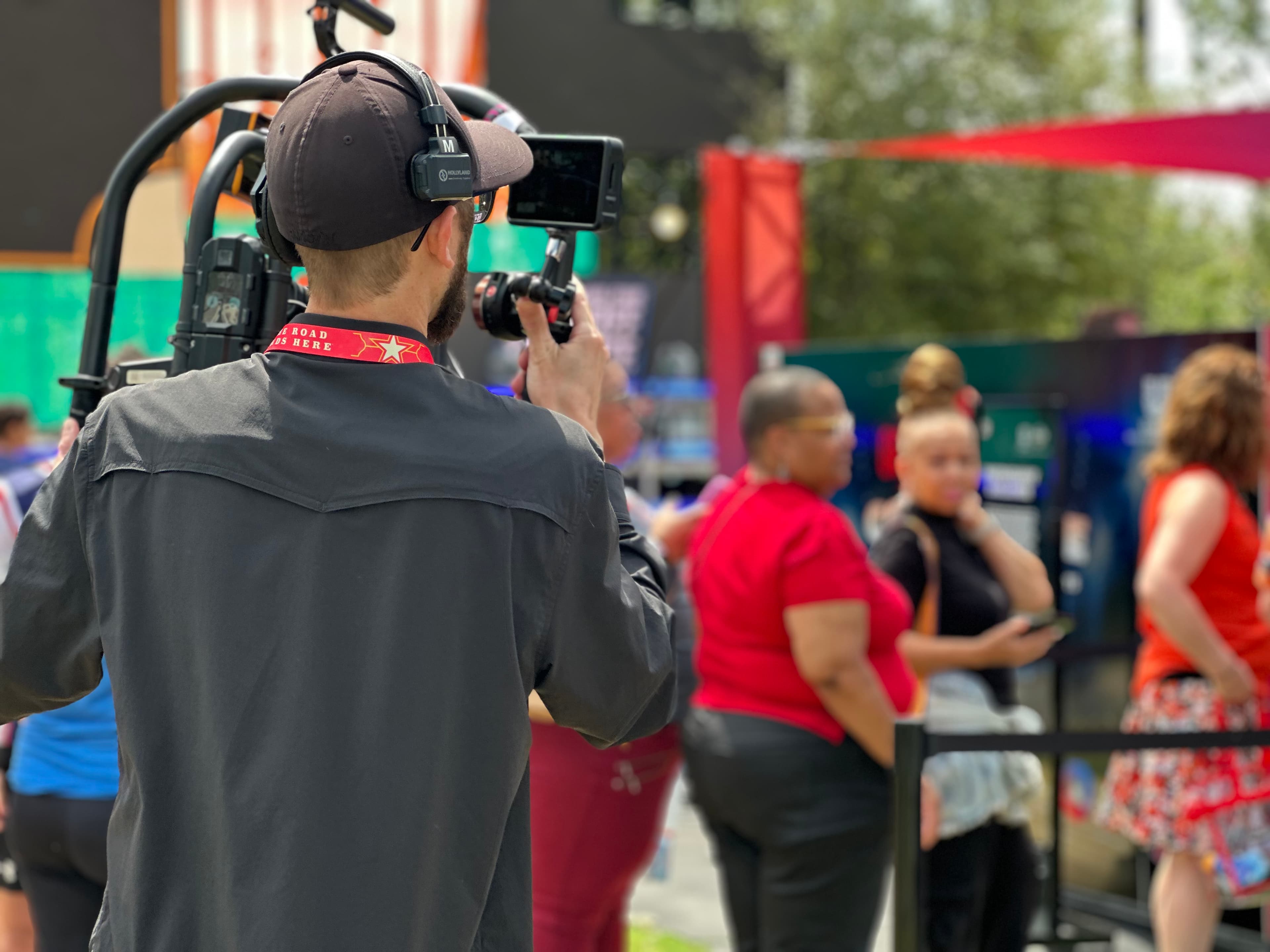 Camera operator covering guests at an outdoor event