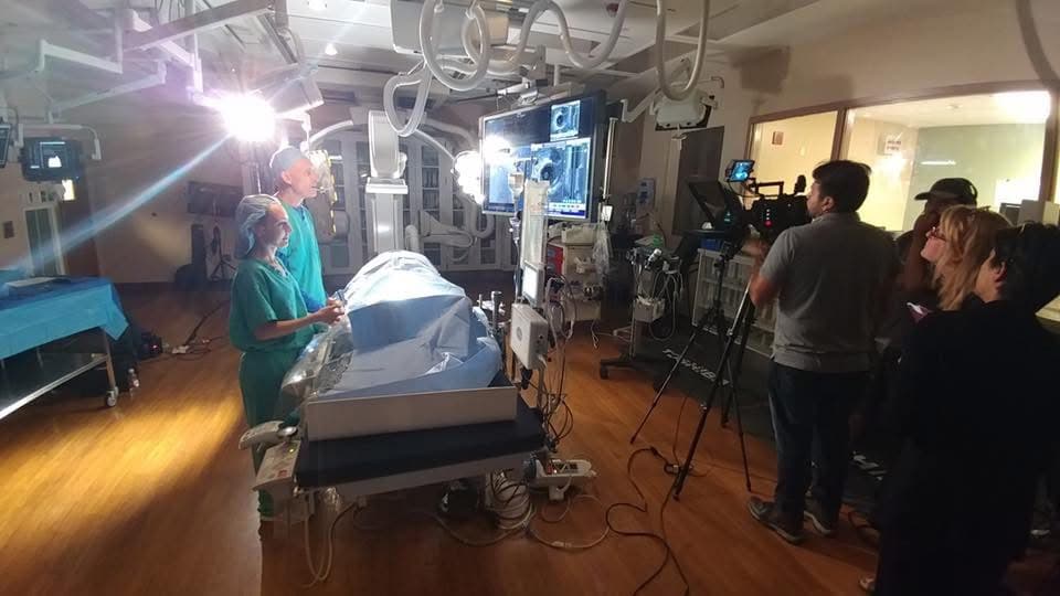 Media Bar crew filming with medical equipment in a clinical environment