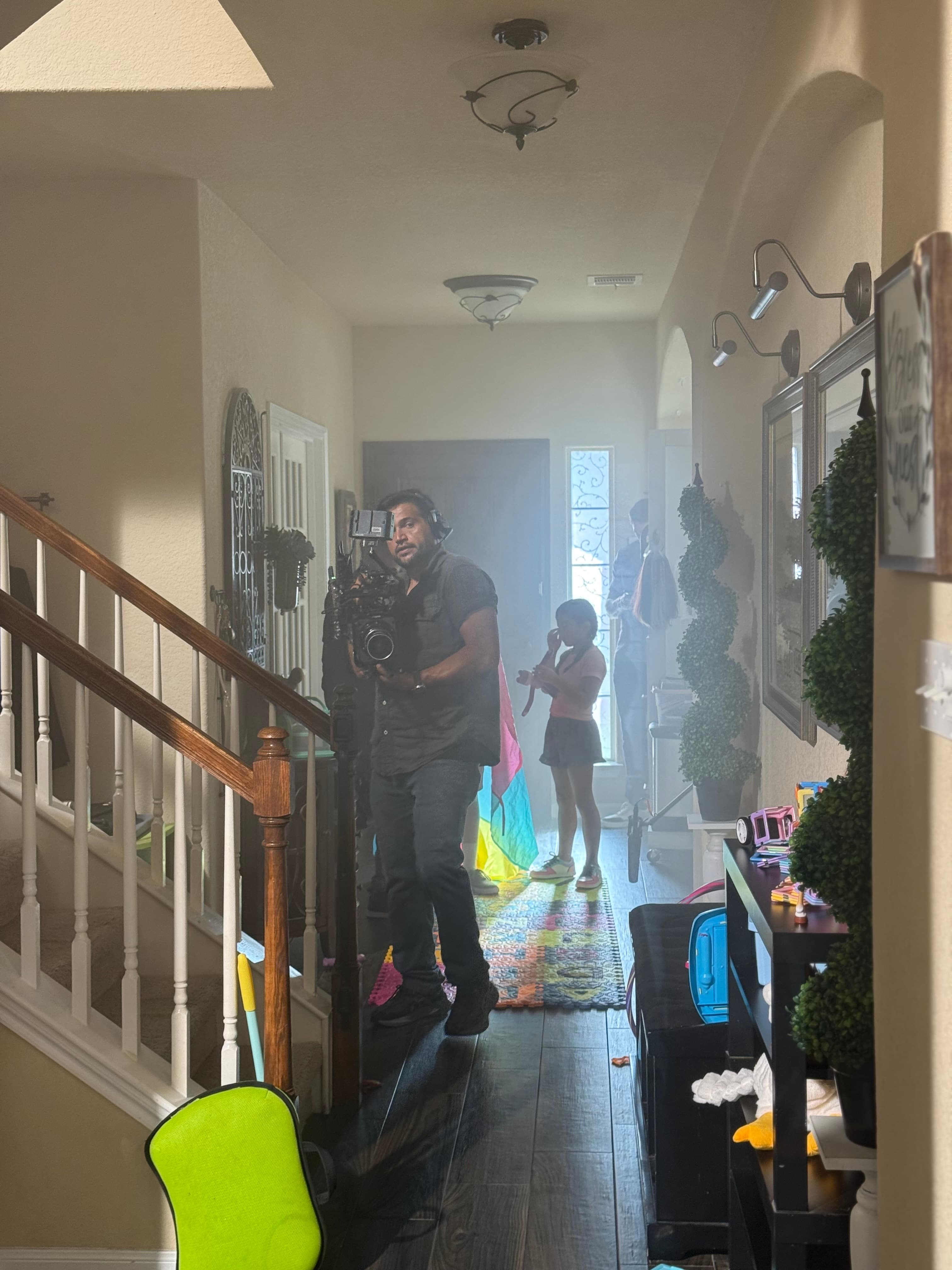 Camera operator working inside a home during a Media Bar production