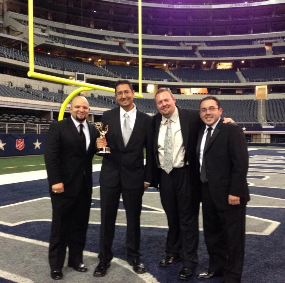 Media Bar Productions team holding an Emmy Award